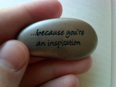 a hand holding a rock that says, because you're an inspiration