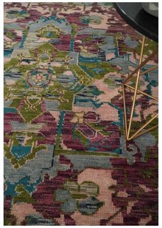 an area rug with various colors and designs on it, including blue, pink, green, purple, and yellow