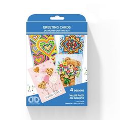 four greeting cards with different designs and colors on the front, one has a teddy bear