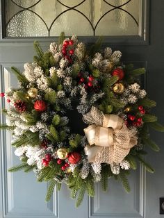 a christmas wreath hanging on the front door