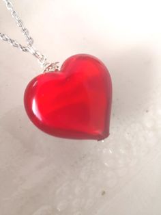 This beautiful Venetian Murano puffed glass heart bead measures 22mm (2.2cm or not far off 1") transparent red glass over a milky glass base. It is enhanced with Sterling silver beads and you can choose your preferred chain option from the drop down menu on the right, just under the price. The shipping cost covers an expedited service from Murano, Italy.  Please be aware that you are responsible for any customs charges your country may levy on you. Glass Heart Necklace, Murano Italy, Glass Heart, Heart Beads, Red Glass, Sterling Silver Bead, Murano Glass, Last Minute Gifts, Silver Beads