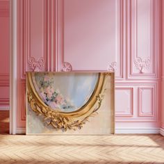 an empty room with pink walls and a gold framed painting