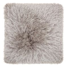 a gray pillow with shaggy fur on it