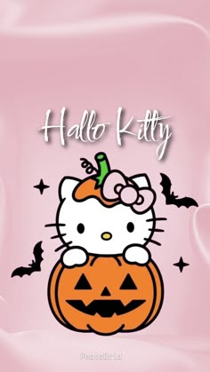 the hello kitty pumpkin is sitting on top of it's halloween pumpkins, with bats