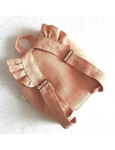 a pink purse sitting on top of a white table