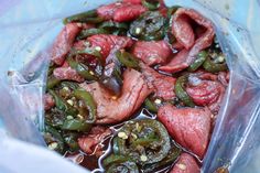 some meat and peppers in a plastic container