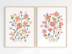 two framed art prints with flowers on the wall next to each other, one is pink and orange