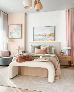 a bedroom with pink and white walls, beige bedding, two blue chairs and a painting on the wall