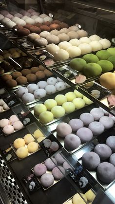 a display case filled with lots of different types of donuts