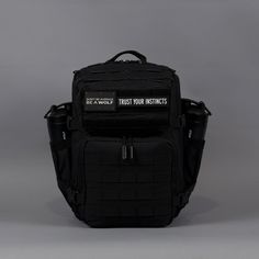 a black backpack with the words trust your victims written on it, against a gray background