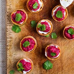 small appetizers are arranged on a cutting board