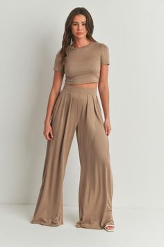 The Cara Pants Set offers a versatile and stylish option for any occasion. With its crop top and palazzo pants set, you can easily dress it up or down. The mock neck and short sleeves provide a chic touch, while the mid-rise and wide leg pants offer comfort and a flattering silhouette. Made with a very stretchy and extra soft fabric, this set is perfect for all-day wear. This style is sold online only. Available for in store pick up. Top And Palazzo Pants, Pants With Pleats, Pleated Palazzo Pants, Fits 2023, Crop Top Pants Set, Flattering Outfits, Airport Outfits, Wide Leg Palazzo Pants, Palazzo Pant