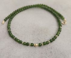 Green jade gemstone beaded chocker,every day necklace Made with smooth 4mm jade beads and 14k solid yellow gold beads and clasp. Please select your prefered length before checkout This minimalist necklace can be worn short as a chocker or longer alone or layered with other necklaces  Measures: 💚4mm  jade smooth beads 💚2mm and 4mm solid gold beads 💚6mm spring ring clasp 100% 14k solid gold hallmarked on clasp Elegant Adjustable Jade Jewelry, Elegant Jade Necklaces With Round Beads, Beaded Jade Jewelry For May Birthstone, Adjustable Jade Jewelry With Spacer Beads, Elegant Jade Round Beads Jewelry, Elegant Jade Jewelry With Round Beads, Elegant Spacer Beads Choker, Dainty Jade Jewelry Gift, Elegant Green Gemstone Beads Jewelry