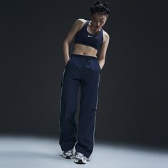 Reaching back to our roots, these easy-fitting pants pull inspiration from the Nike looks of the '70s. A water-repellent finish and UV technology built into the crinkle-woven fabric help keep you good to go come rain or shine. Nike Windrunner, Large Pants, Nike Looks, Modern Clothes, Workout Fits, Wardrobe Pieces, How To Hem Pants, Rain Or Shine, Kids Outerwear