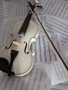 a violin sitting on top of sheet music