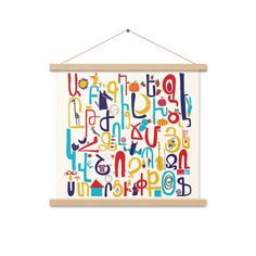 a wooden frame hanging on the wall with colorful alphabets and numbers printed on it