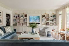 a living room filled with furniture and bookshelves