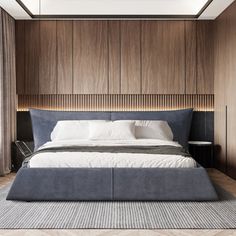 a large bed sitting in the middle of a bedroom next to a wooden headboard