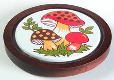 a small wooden box with an image of mushrooms on it's front and sides