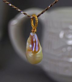 Lillia  Huge natural untreated color nucleated pearl by LusterWear #Pearl #Natural #UntreatedPearl #PearlJewelry #PearlPendant #PearlNecklace #Gold #Huge #HugePearl #NaturalPearl #Beautiful #Stunning #Freshwater #Nucleated #NucleatedPearl #FreshwaterPearl #Rare #Classy #Simple #ForSale #EtsyShop #EtsyJewelry #EtsySeller #Handmade #Etsyhandmade #SelfMade #MadeInUSA #Craft #art #Fashion #WomensFashion #WomensJewelry #WomensPearls #PearlLover #Gift #GiftIdea #Present #BirthdayPresent #Wedding Exquisite Gold Jewelry With Pearl Charm, Unique Gold Pearl Jewelry, Unique High Luster Jewelry For Wedding, Yellow Gold Pear-shaped Pearl Necklace, Unique High Luster Wedding Jewelry, Gold Pearl Necklace With High Luster, Gold High Luster Pearl Necklace In Fine Jewelry Style, Gold High Luster Pearl Necklace Fine Jewelry, Exquisite Pear-shaped Pearl Drop Jewelry