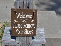 a sign that says welcome please remove your shoes