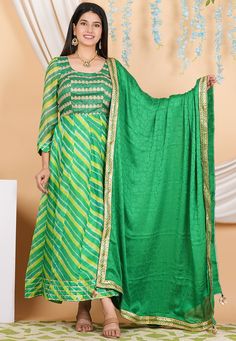 Pure Kota Silk and Art Silk Anarkali Kameez in Green Color. This Readymade Round Neck and Quarter Sleeve attire with Shantoon Lining is Enhanced with Leheriya Print, Zari ,Sequins and Gota Lace Work. Available with a Shantoon Churidar in Green and a Fancy Lace Border Faux Crepe Jacquard Dupatta in Green Color. The Kameez and Bottom Lengths are 52 inches respectively.   Do note: 1.)Accessories shown in the image are for presentation purposes only and length may vary up to 2 inches. 2.)Slight vari Semi-stitched Resham Embroidered Anarkali Set, Semi-stitched Anarkali Set With Resham Embroidery, Semi-stitched Resham Embroidery Anarkali Set, Anarkali Salwar Kameez With Dupatta, Resham Embroidery Semi-stitched Anarkali Set, Semi-stitched Dola Silk Kurta With Cutdana, Transitional Anarkali Style Floor-length Palazzo Set, Anarkali Chinon Churidar For Festivals, Bollywood Style Green Palazzo Set For Navratri