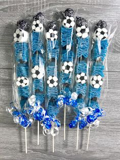 blue and white lollipops with soccer balls on them