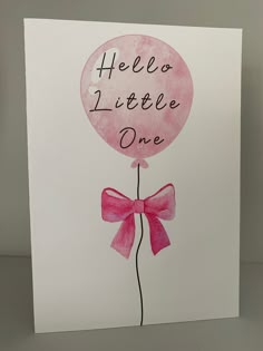 a pink balloon with a bow on it that says hello little one in black ink