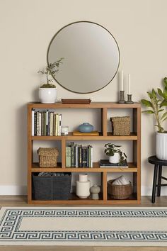 a bookshelf with various items and a round mirror