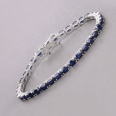 14k Gold Blue Sapphire Bracelet, Genuine Blue Sapphire Ovals Gold Bracelet for Women, Blue Sapphire Gold Tennis Bracelet, Gift for Her Celebrate the elegance of September with this luxurious 14K white gold tennis bracelet, featuring 7.48 carats of genuine oval blue sapphires. The deep blue sapphires, September's birthstone, are beautifully set in white gold, creating a striking and sophisticated piece. Designed with a secure box clasp, this bracelet offers both beauty and functionality. Perfect Classic Blue Bracelet Jewelry, Elegant Sapphire Sterling Silver Bracelet As Gift, Elegant Blue Sterling Silver Bracelet As Gift, Elegant Blue Sterling Silver Bracelet For Gift, Classic Blue Sterling Silver Bracelets, Classic Blue Sterling Silver Bracelet, Classic Blue Bracelets, Classic Blue Jubilee Bracelet, Oval Blue Sterling Silver Bracelet As Gift