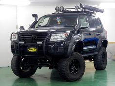 a large black truck parked in a garage