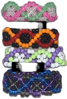 several different types of beaded bracelets are stacked on top of eachother