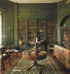 a living room filled with furniture and bookshelves