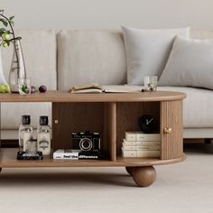 This coffee table features two sliding grooved tambour doors, round wood legs, and metal handle detailing, allowing you to store anything from books to remotes within the flexible compartments. A sleek ash wood countertop brings an adventurous, unique feel to your living room, allowing you to reconfigure the room's style. Constructed of solid Ash wood Kiln-dried wood helps prevent warping, splitting, cracking and developing mildew Featuring a grooved tambour door design Four round column legs pr Modern Walnut Coffee Table, Fluted Coffee Table, Walnut Living Room, Wood Coffee Table With Storage, Walnut Coffee Table Modern, Tambour Doors, Tambour Door, Round Column, Stemware Storage