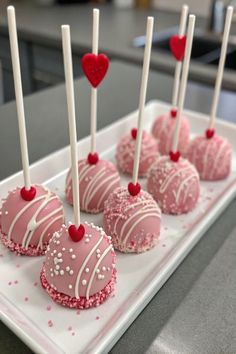 there are many heart shaped cake pops on the plate