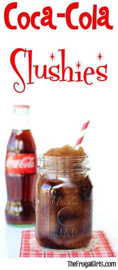 two jars filled with coke and ice cream sitting on top of a red checkered table cloth