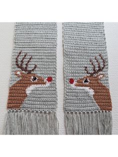 two crocheted scarfs with deer heads and antlers on the sides, one is