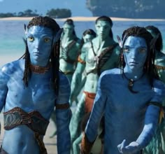 the blue man group from avatar is standing in front of an ocean with other people