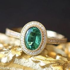 - Sophisticated Oval Engagement Ring Vintage - Superior Quality and Craftsmanship - Nature Inspired Green Ring - Vivid Green Natural Emerald - Ethically Sourced Gemstones - Conflict Free Diamonds - Made in the USA Have you ever seen something more beautiful than emerald ring in yellow gold surrounded by a sparkly diamo Luxury Oval Emerald Birthstone Ring, Gold Tsavorite Emerald Ring For Formal Occasions, Formal Gold Emerald Ring With Tsavorite, Classic Gold Ring With Tsavorite, Oval Tsavorite Diamond Ring For Formal Occasions, Timeless Gold Diamond Ring With Emerald, Luxury Gold Oval Emerald Ring, Formal Green Emerald Ring With Halo Design, Luxury Emerald Ring With Halo