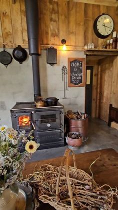 an old fashioned wood stove in a rustic kitchen with sunflowers on the table