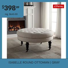 a round ottoman in front of a fireplace with the price $ 399 99 reg $ 545 00