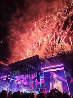 fireworks are lit up in the sky above a stage