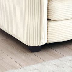 a white couch sitting on top of a wooden floor