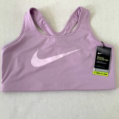 Nike Dri-Fit Swoosh 1x Plus Size Lavender/Light Purple Sports Bra Purple Casual Activewear For Light Sports, Purple Athleisure Activewear For Sports Season, Nike Stretch Tops With Light Support, Purple Activewear For Light Sports, Nike Tops With Light Support For Workout, Nike Workout Top With Light Support, Purple Activewear For Casual Sports, Breathable Purple Tops For Sports, Purple Activewear For Training