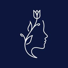 a woman's face with a flower in her hair on a dark blue background