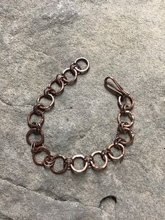 Men's copper bracelet of 14 ga. wire with hook closure. Length is 8.5 inches and is adjustable. Can be made to order if different length is needed. Handmade Adjustable Rose Gold Chain Bracelet, Bronze Copper Bracelets For Jewelry Making, Elegant Handmade Copper Bracelets, Copper Bracelets With Lobster Clasp For Gift, Brown Copper Wire Wrapped Bracelets, Handmade Artistic Copper Bracelet, Bronze Copper Wire Bracelet, Nickel-free Bohemian Copper Bracelets, 100% Copper Braclet