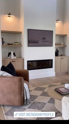 a living room filled with furniture and a flat screen tv mounted on the wall above a fireplace