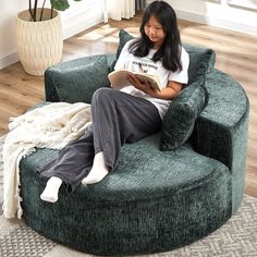 a woman sitting in a chair reading a book