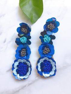 This beaded blue sequin flower earring scream wow and absolutely beautiful. Has 4 drop flowers with beaded sequin. Length: 3 inches long Blue 3d Flower Drop Earrings, Blue Handmade Flower Earrings, Handmade Blue Flower Earrings For Party, Handmade Blue Flower Earrings, Blue Beaded Dangle Flower Earrings, Beaded Dangle Flower Earrings For Party, Blue Drop Flower Earrings For Party, Blue Dangle Flower Earrings For Party, Blue Bohemian Flower Earrings For Party