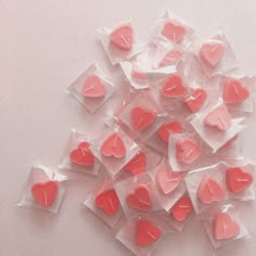 small pink hearts in plastic bags on a white surface